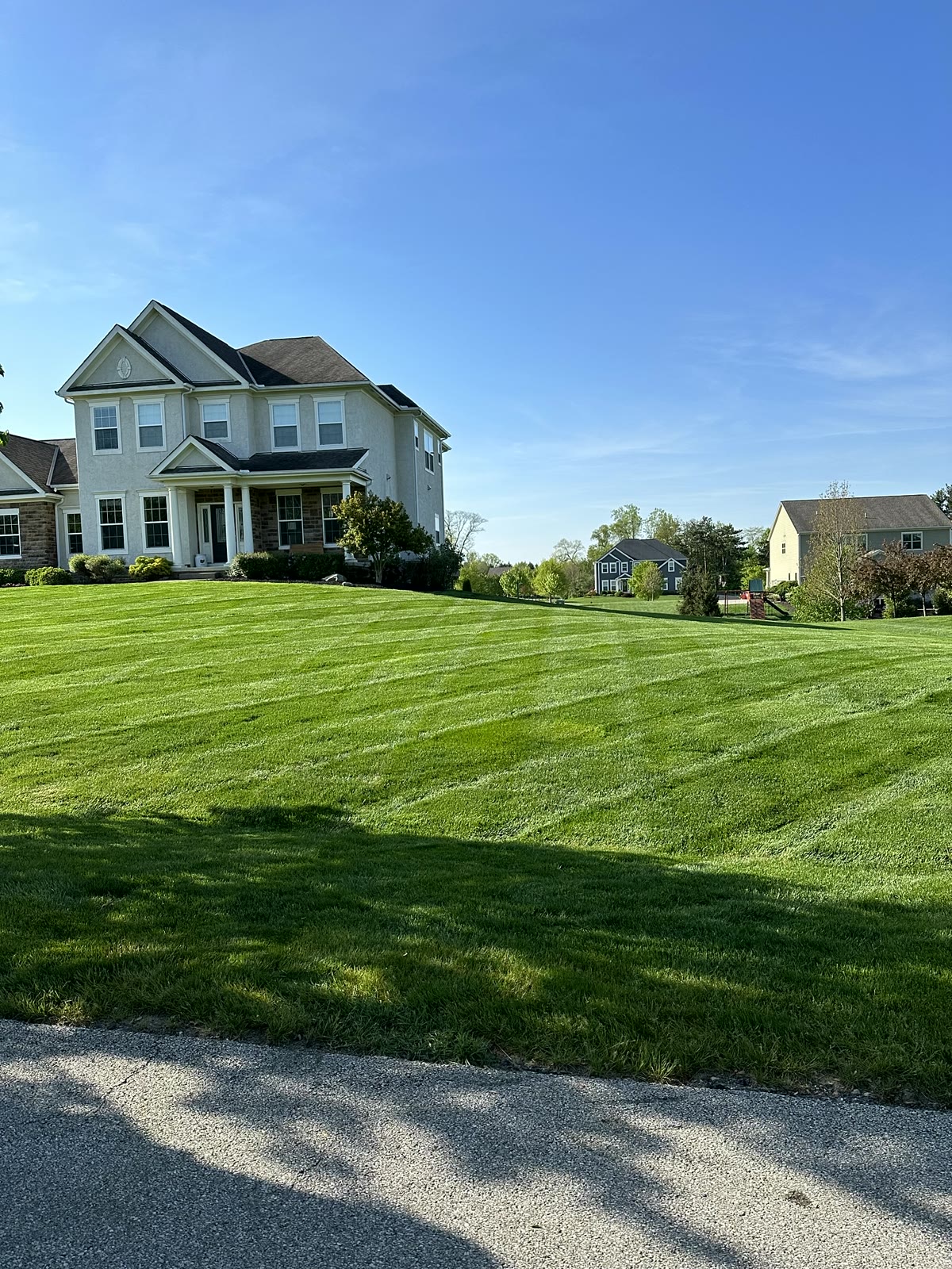 Freshly striped front lawn at a two-story home