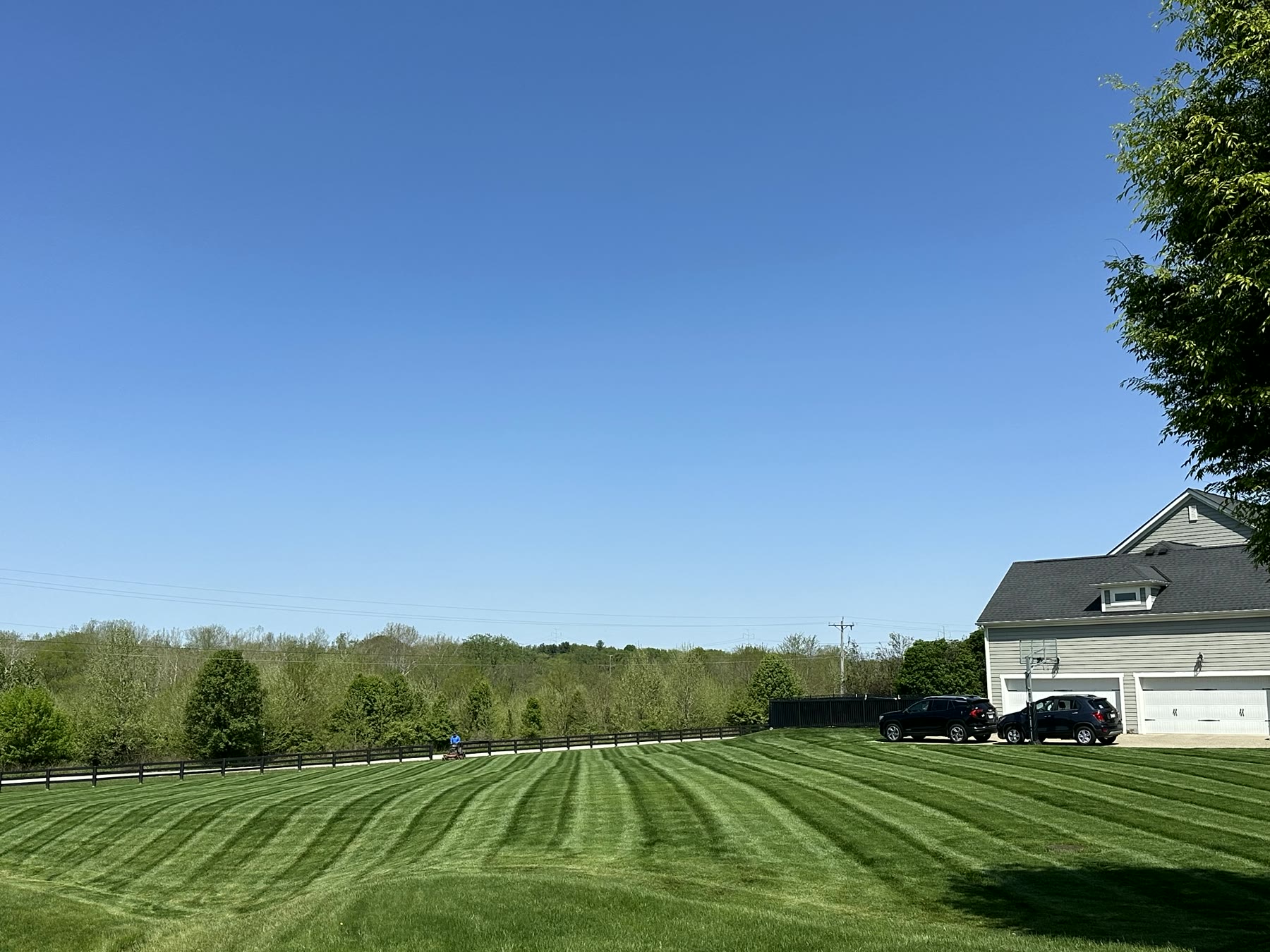 Striped lawn beside a three-car garage