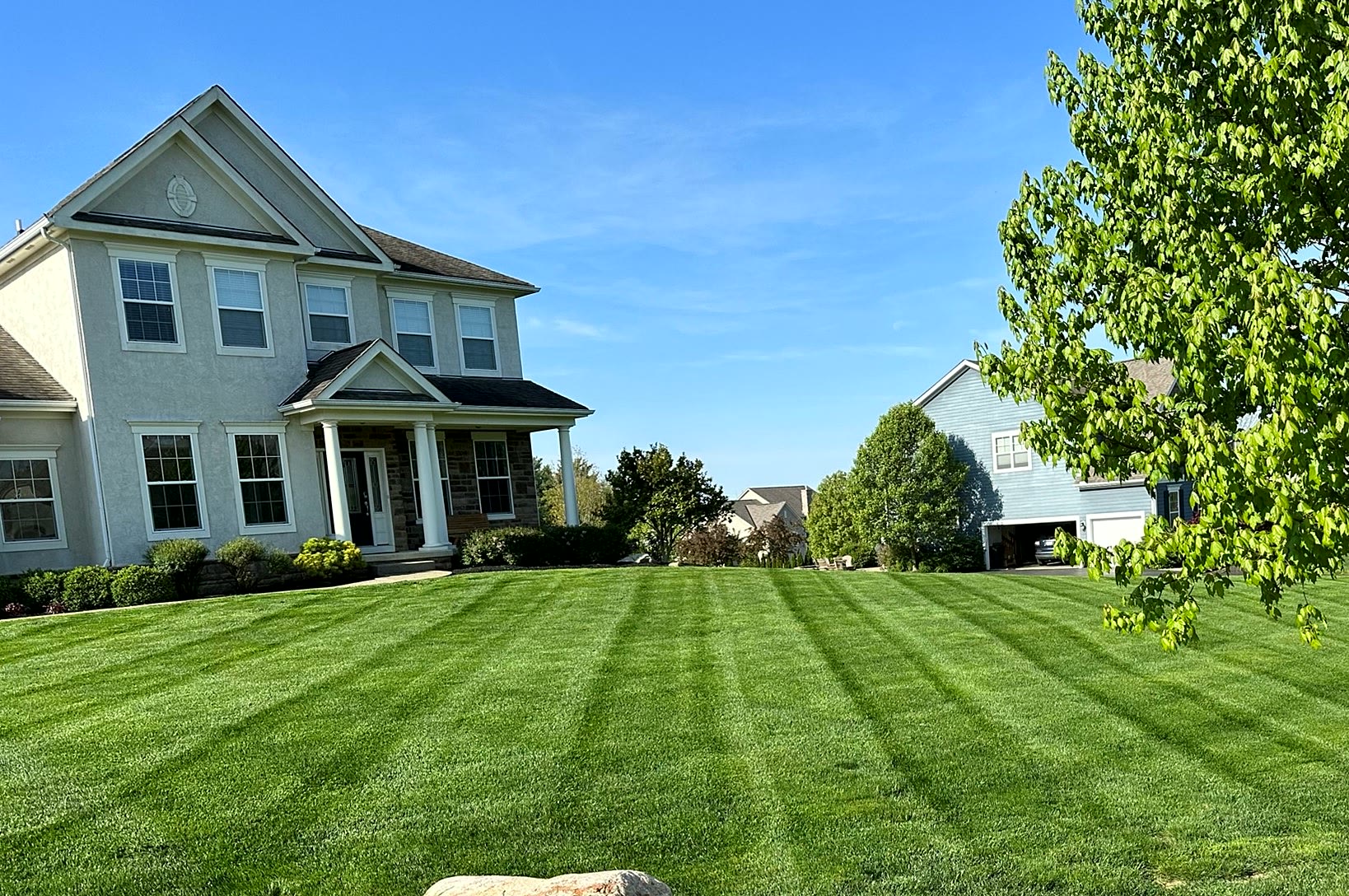 Freshly striped front lawn at a two-story home in Central Ohio